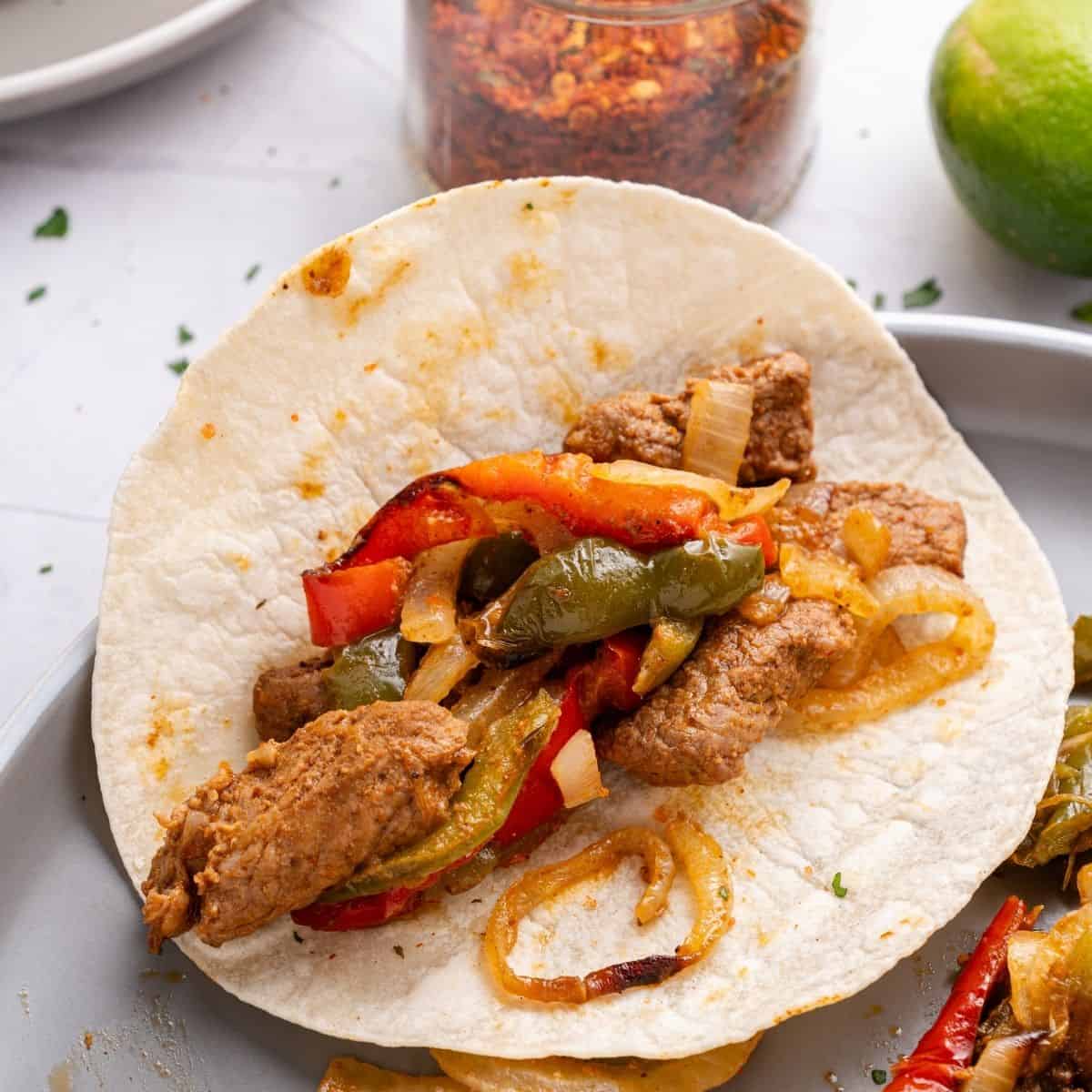 Air Fryer Beef Fajitas, a quick and easy meal recipe made with fresh vegetables and meat in less than a half hour.