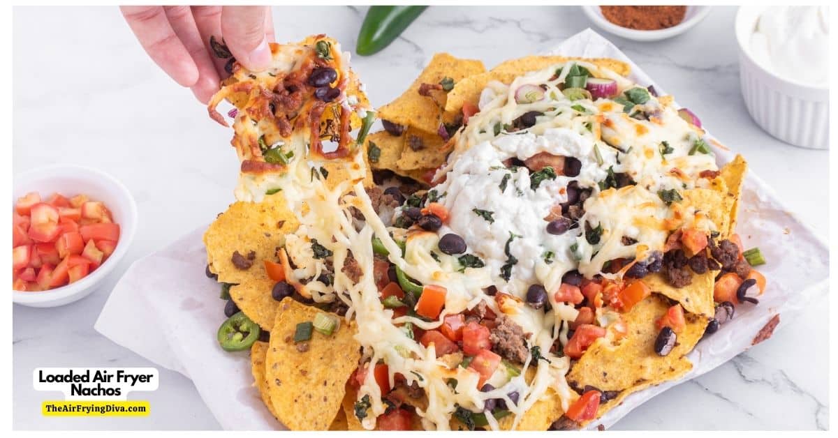 Loaded Air Fryer Nachos (with video), a quick and delicious meal or snack recipe featuring tortilla chips topped with gooey cheese and more.