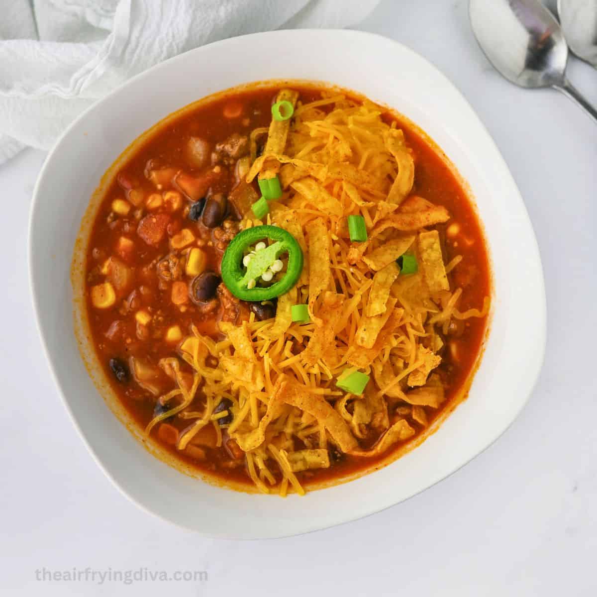 Slow Cooker Taco Soup Recipe, a simple and delicious crockpot recipe for hearty and flavorful soup made with simple ingredients.