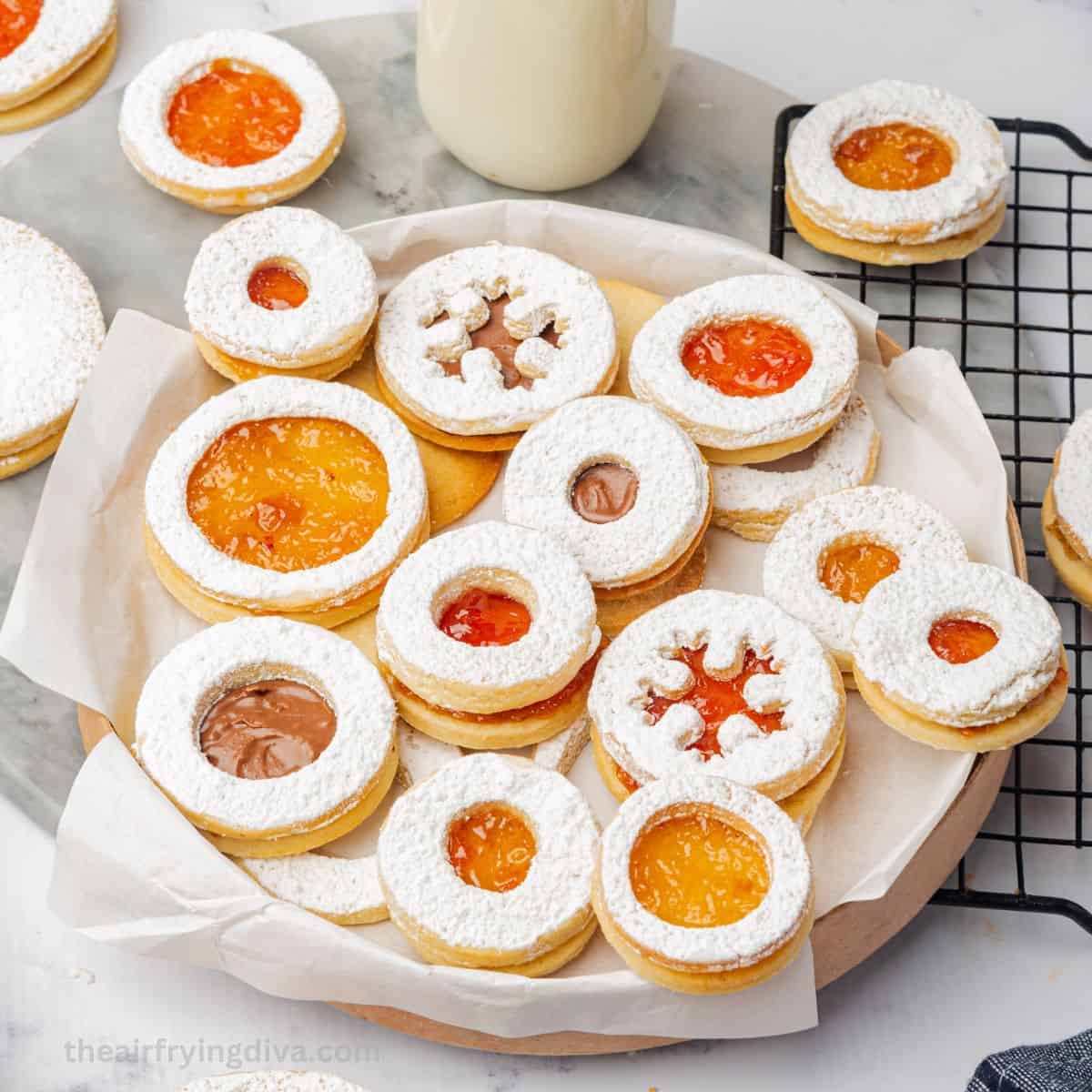 Air Fryer Holiday Linzer Cookies, a delicious Christmas cookie sandwich made with air fried almond cookies  with a jam center.