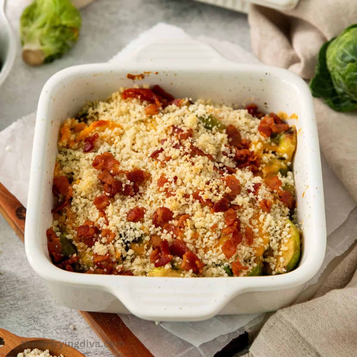 Bacon and Brussel Sprout Casserole, a simple, comforting, and savory baked dish  in a creamy sauce and topped with cheddar cheese.