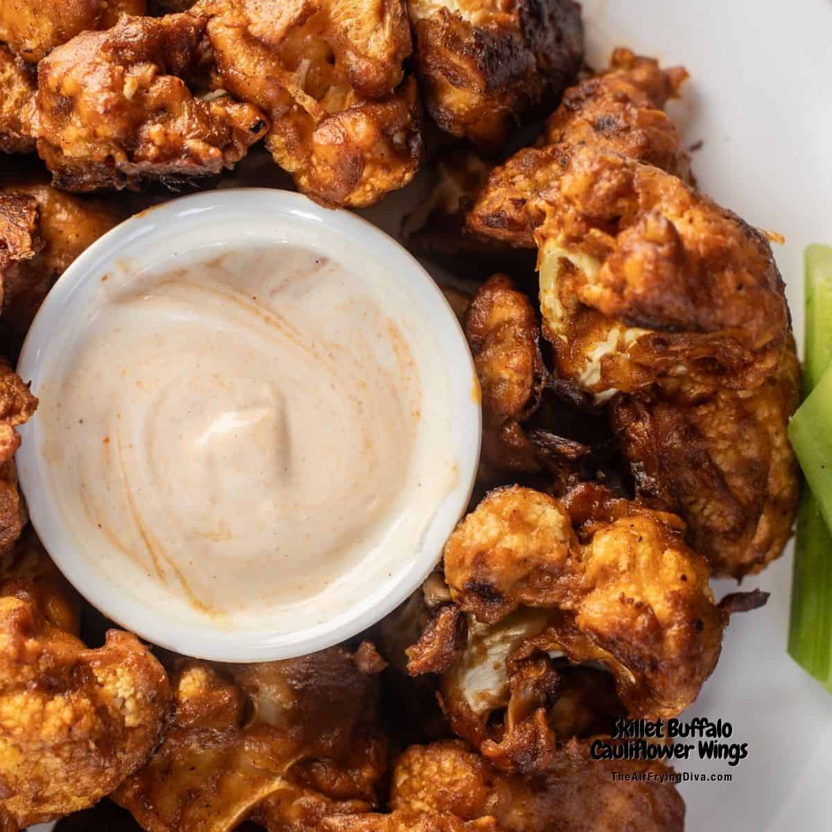 Skillet Buffalo Cauliflower Wings, lightly breaded cauliflower perfectly cooked crisp in a cast iron skillet and coated in buffalo sauce.
