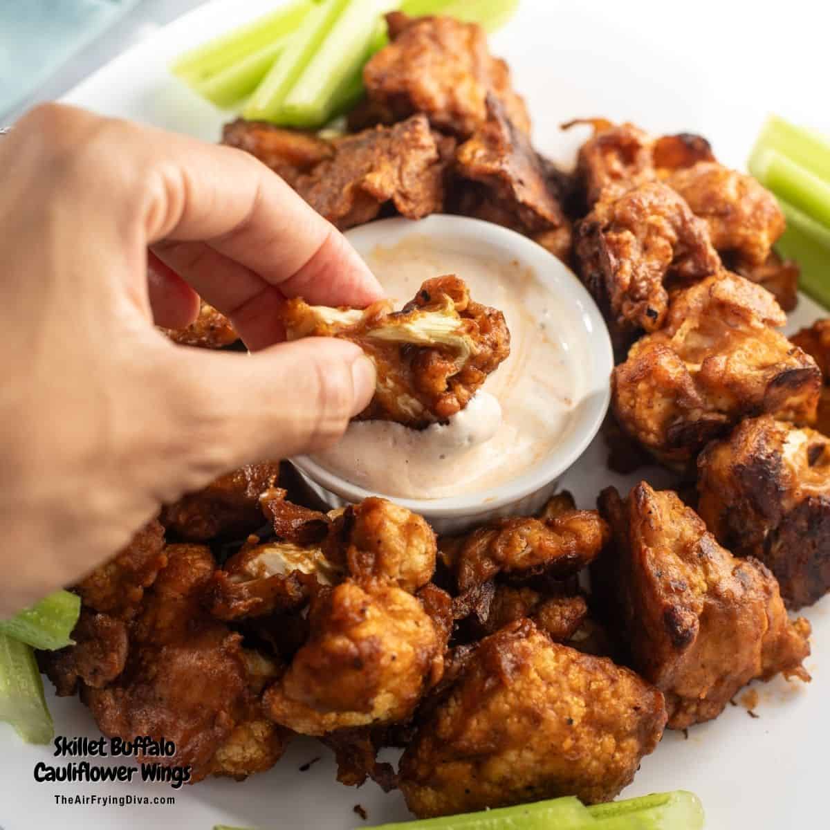 Skillet Buffalo Cauliflower Wings, lightly breaded cauliflower perfectly cooked crisp in a cast iron skillet and coated in buffalo sauce.