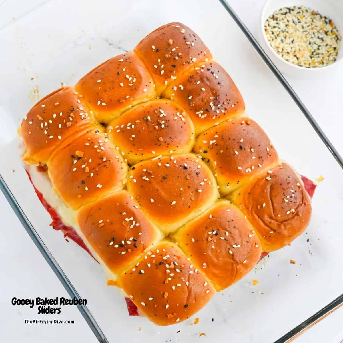 Gooey Oven Baked Reuben Sliders are the ultimate party snack! Layers of tender corned beef, Swiss cheese, and sauerkraut on Hawaiian rolls.