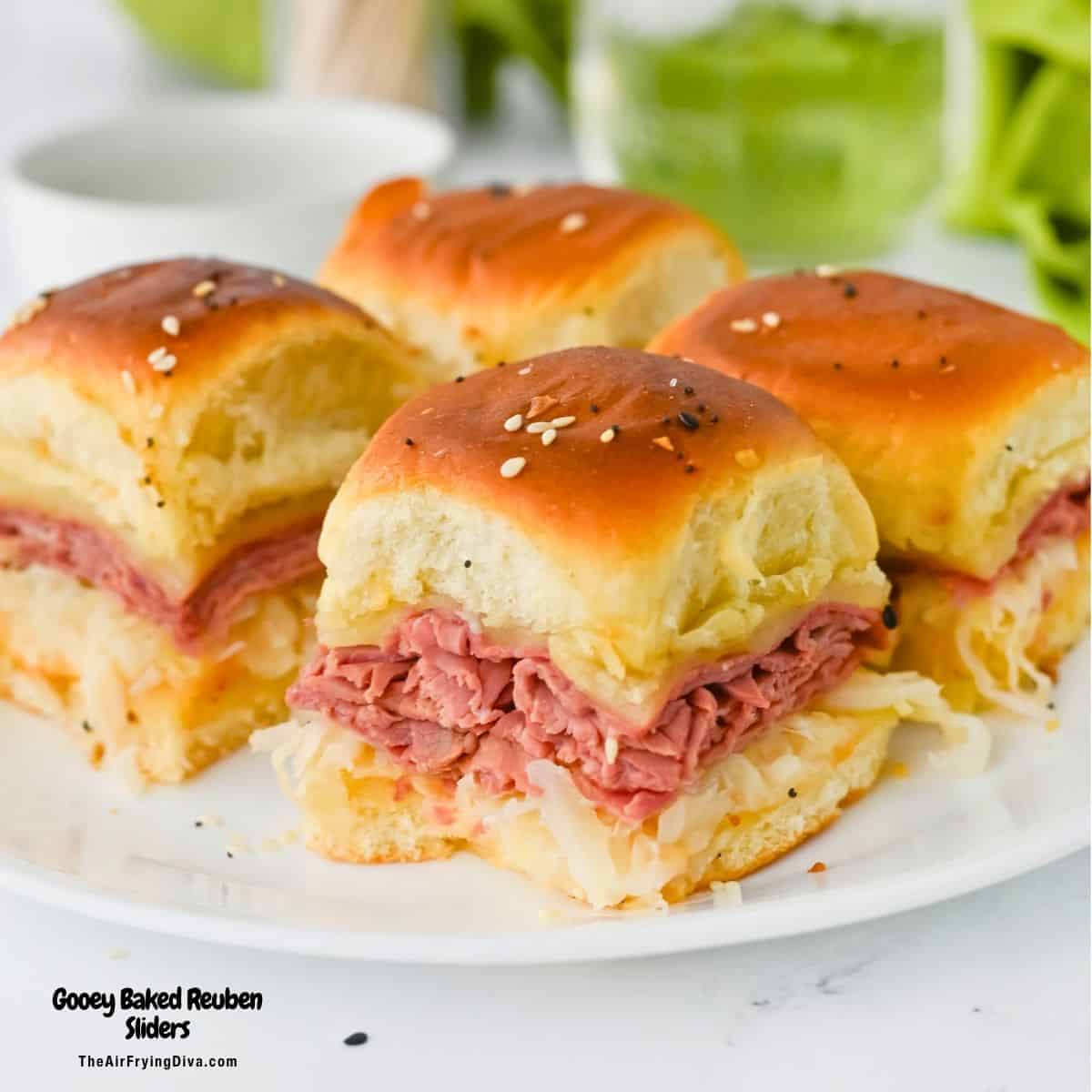 Gooey Oven Baked Reuben Sliders are the ultimate party snack! Layers of tender corned beef, Swiss cheese, and sauerkraut on Hawaiian rolls. Gooey Oven Baked Reuben Sliders are the ultimate party snack! Layers of tender corned beef, Swiss cheese, and sauerkraut on Hawaiian rolls.