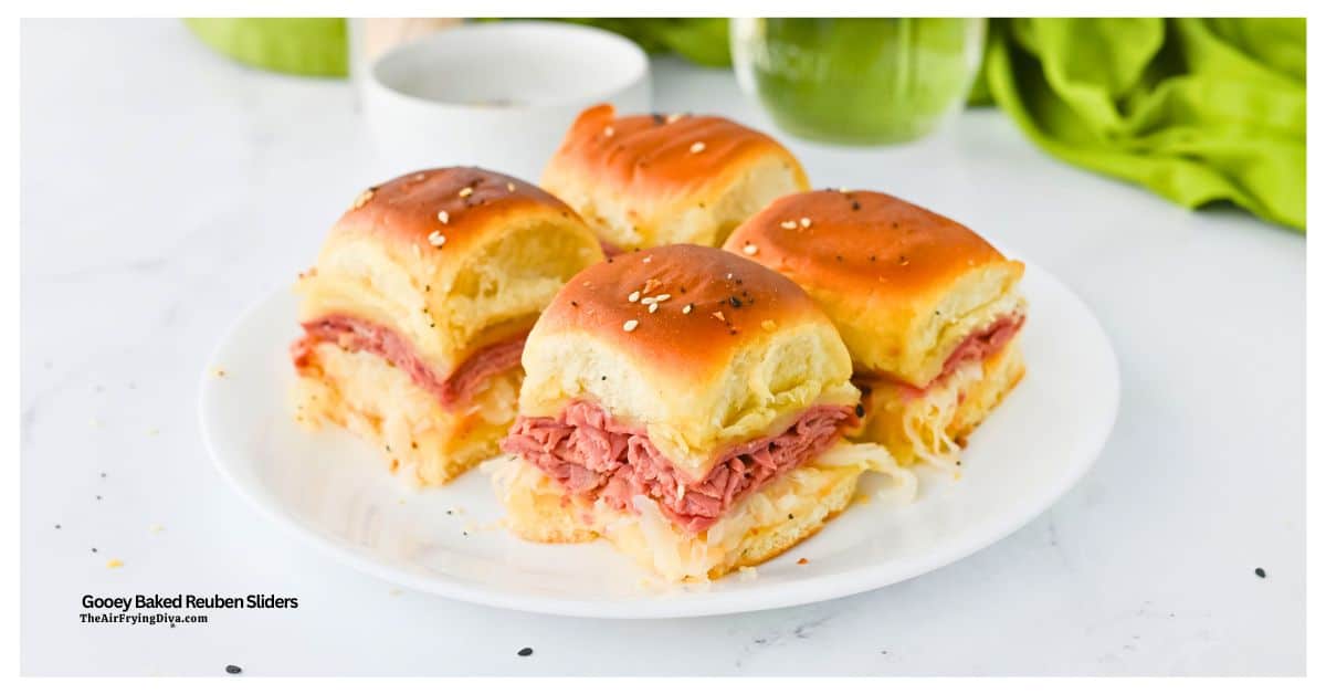 Gooey Oven Baked Reuben Sliders are the ultimate party snack! Layers of tender corned beef, Swiss cheese, and sauerkraut on Hawaiian rolls. Gooey Oven Baked Reuben Sliders are the ultimate party snack! Layers of tender corned beef, Swiss cheese, and sauerkraut on Hawaiian rolls.