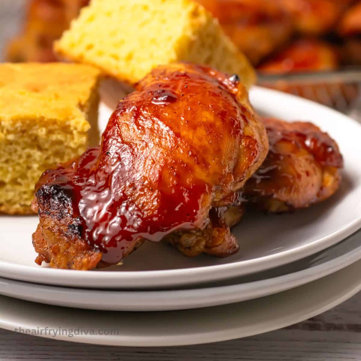 Easy BBQ Air Fryer Chicken Thighs recipe featuring savory and incredibly juicy chicken with a sticky barbecue glaze air fried to perfection. Easy BBQ Air Fryer Chicken Thighs
